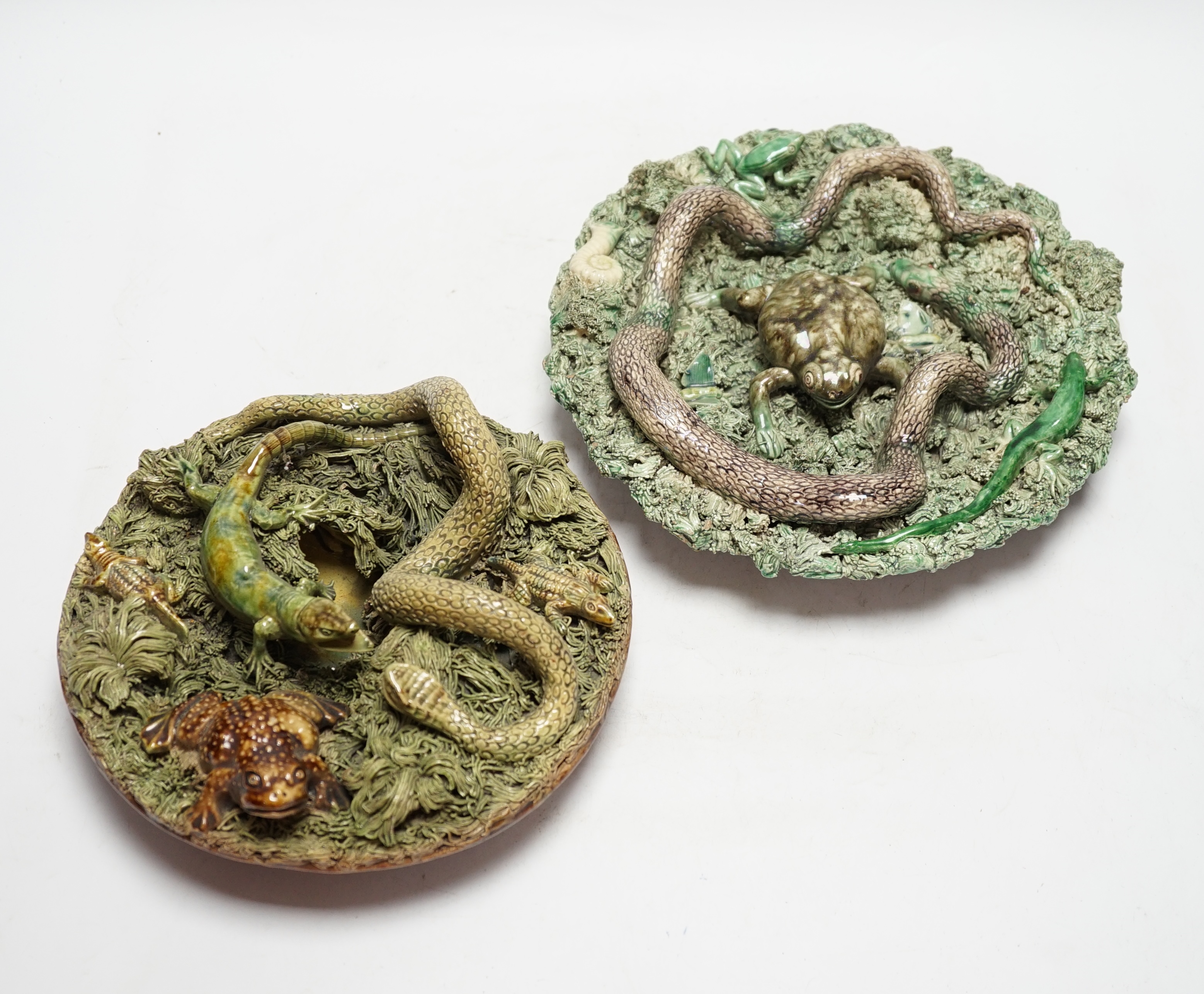 Two Caldas Palissy ware dishes decorated with frogs, snakes and a lizard, the larger 24cm diameter